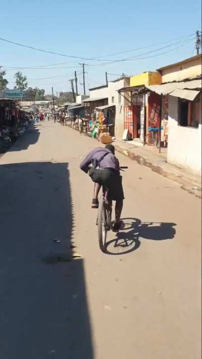 African guy riding the bike like an absolute legend ?
