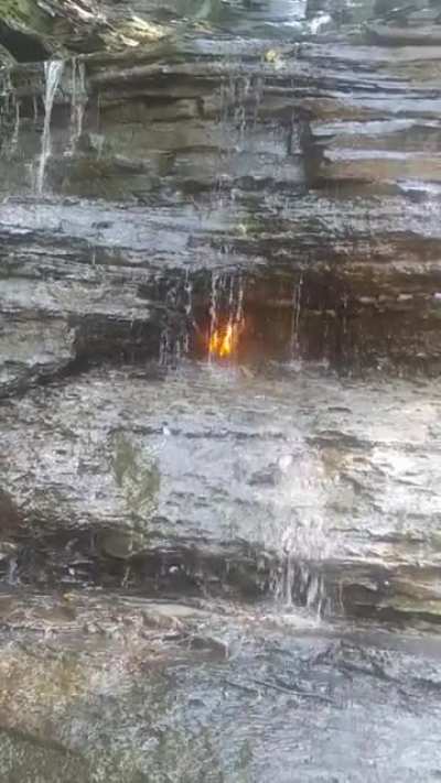 ?Naturally-occurring gas emission behind waterfall that can be ignited, Eternal Flame Falls, NY