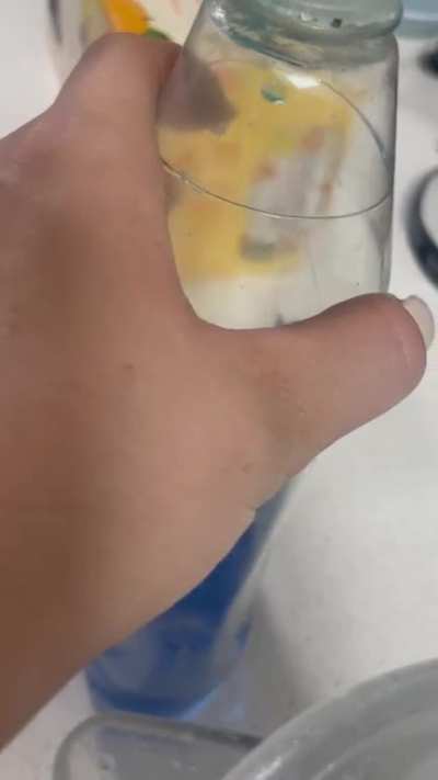 Can anyone explain this soap bubble in our dish soap that sporadically floating and moving on the same invisible plane? Is this a glitch in the simulation?
