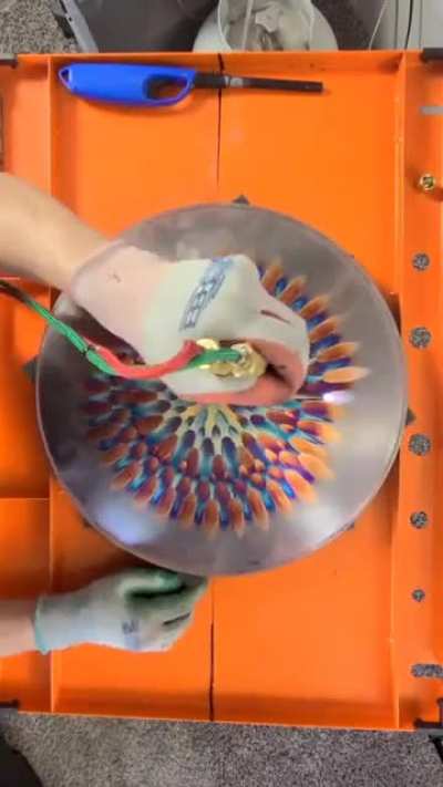 The way he controls the flame to produce different colors