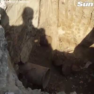 Construction workers unblock explosive pipe