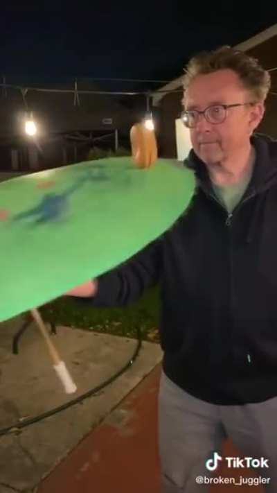 This man is actually spinning a fucking burger on an umbrella