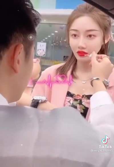 Giving her a hand on her lipstick