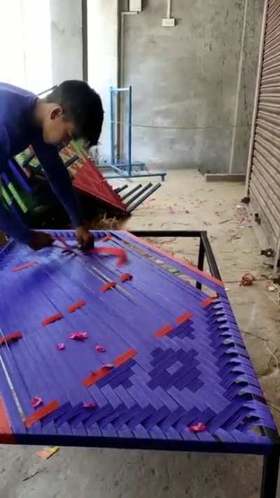 Weaving a "Charpai"( Indian bed )