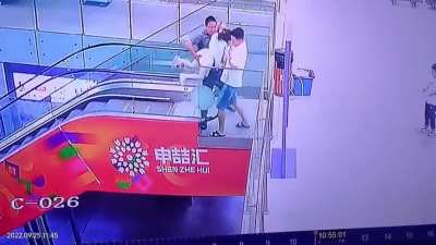 Little girl hangs onto escalator handrail