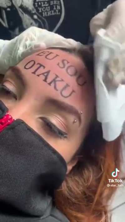 Teen couple tattooing "I'm an Otaku" on their forehead