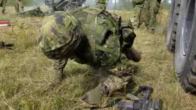 Canadian troops wake up their sleeping comrade using an artillery gun