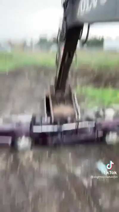 Crushing cars with an excavator.