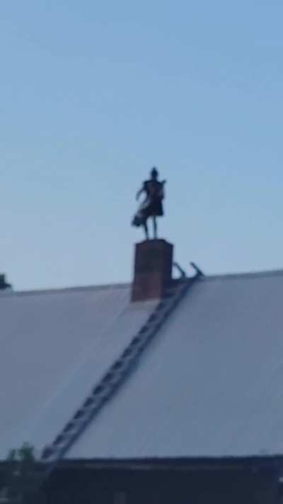 Man throwing some heavy bars on a roof