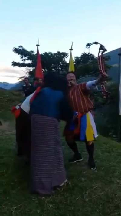 Apparently, It's a tradition in Bhutan to see if a man can shoot straight when his manhood is being touched.