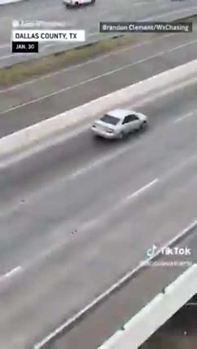 Texans driving over an icy bridge