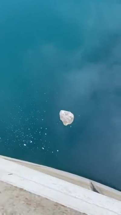 Dropping a big rock from a dam