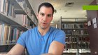 Guy pulls the rarest card he can in Pokemon pack openings, in the library and tries to keep his excitement contained