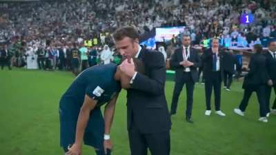 French President Emmanuel Macron consoling Kylian Mbappé after losing to Argentina in the world cup final 2022