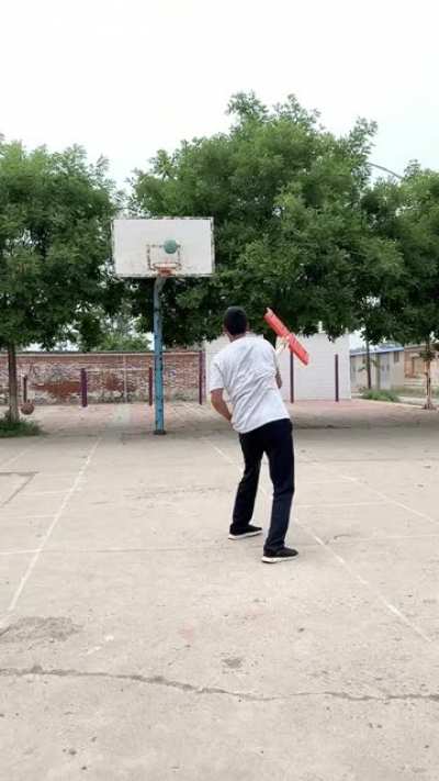Throwing two basketball at the same time while facing opposite side!