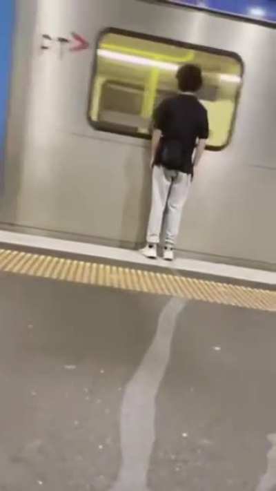 Trying to be funny by standing really close to a passing train.