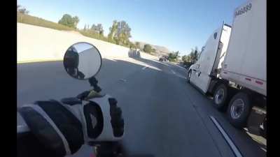 Guy loses control of his bike and narrowly escapes death.