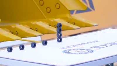Guy manages to stack 5 hex nuts using an excavator