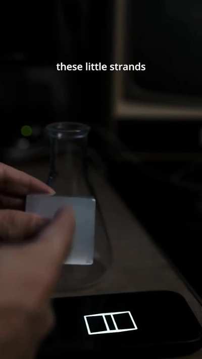 This is a "Pepper's Ghost" reflection effect from the surface of a selenite cube.