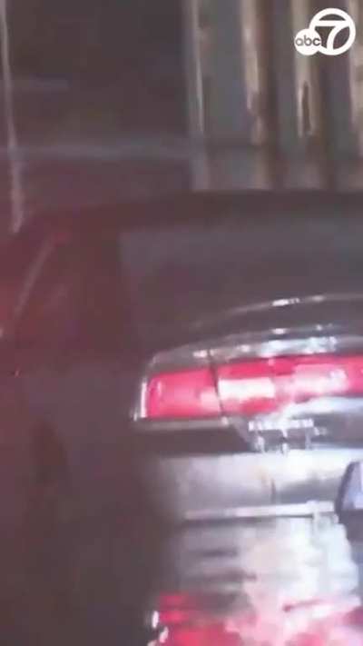 Driver attempts to drive straight through high floodwater in front of live news crew