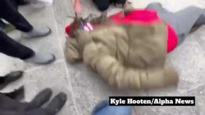 Woman screaming "Fuck America" and collapsing on the floor outside a courthouse