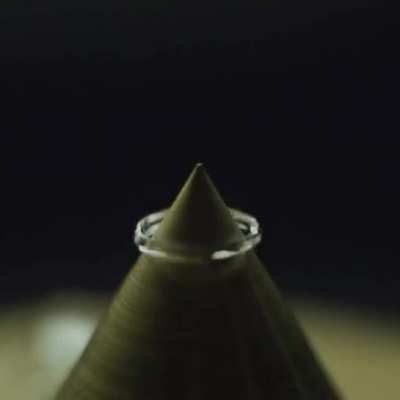 Drop of water falling on a sharp point