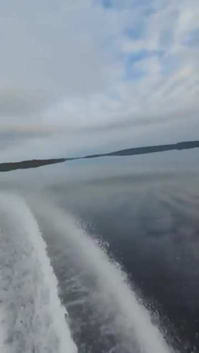 Someone on a jetski on a fully reflective lake