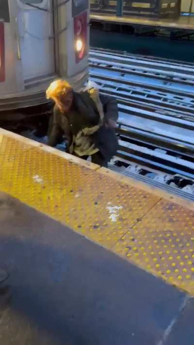 Man crawls out from under the train he was dragged by, and cammer just keeps recording