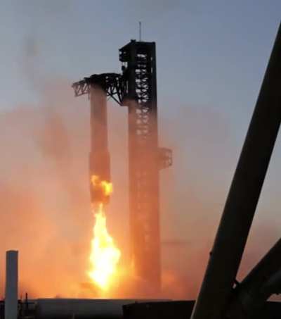 Starship Booster is caught from mid-air during landing