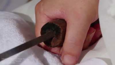 Hot iron for nakjuk (Korean bamboo pyrography) is used to burn poems and patterns onto a sword sheath