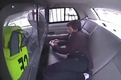 Breaks out of the handcuffs and then tries to light the Police car on fire with his trusty Zippo