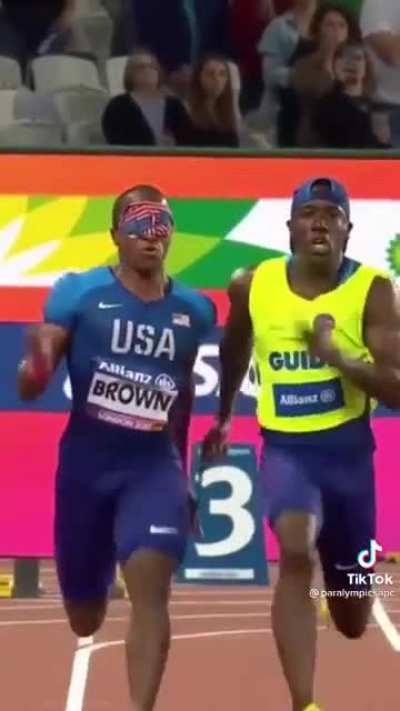 Clip from the Paralympics. David Brown is a blind sprinter, his partner helps keep him on track and cheers him on as they run. "Go David, go David."