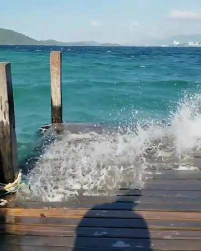 Waves going through a wooden dock