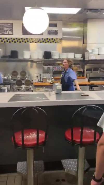 Waffle House employee casually blocks thrown chair