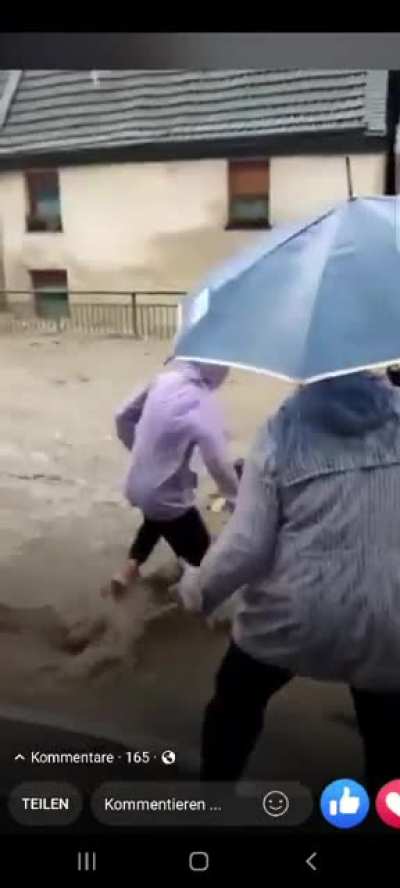 People saving a fireman from drowning during today's catastrophic floodings in Germany