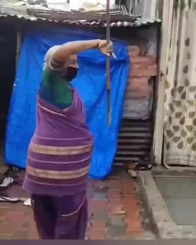 Sari-clad octagenarian performing the art of 'lathi-kathi' from Pune, India.