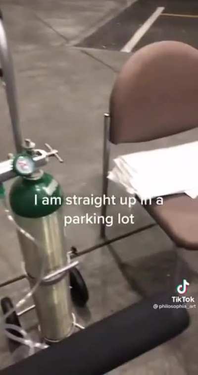 Hospital patient in hysterical disbelief as she's treated in the parking lot