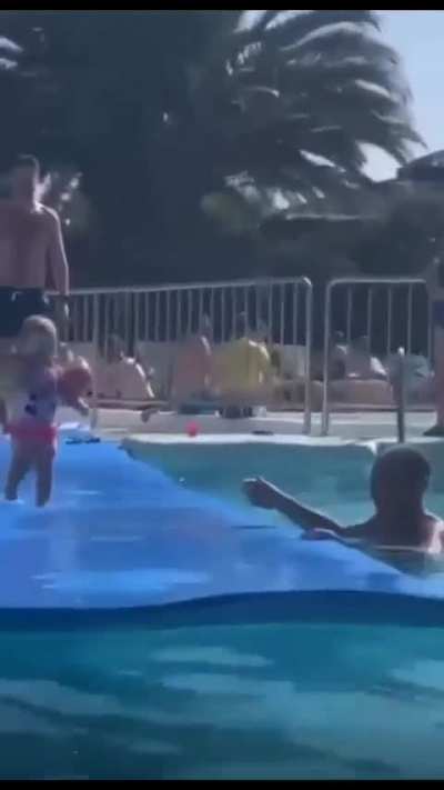 Ababy is about to dive into the water, be careful!