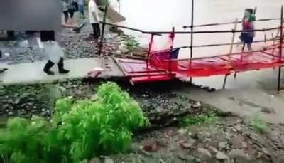 Woman just made it across failing bridge.
