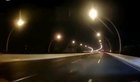 A car fell off a 30-foot-high overpass after another car collided into it in Shanghai. The driver survived with head injuries.