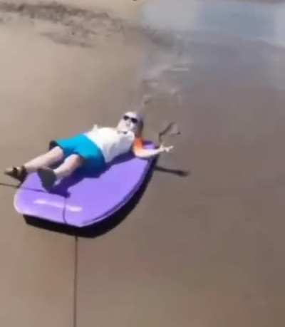 Cool baby being pulled on a bodyboard
