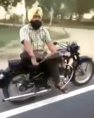 reading a book with both hands sitting sideways (60kmph)