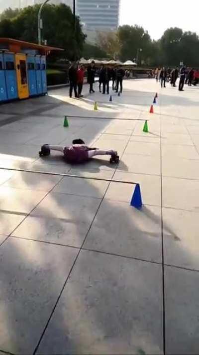 Kid slide through extreme low poll wearing Roller skates