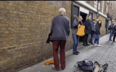 Taking a short cut behind a street performer