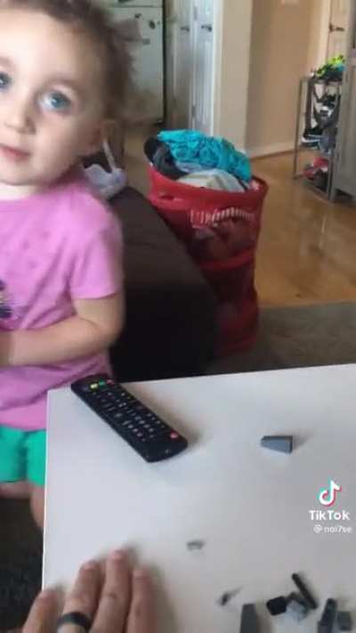 Little girl can’t find the remote.