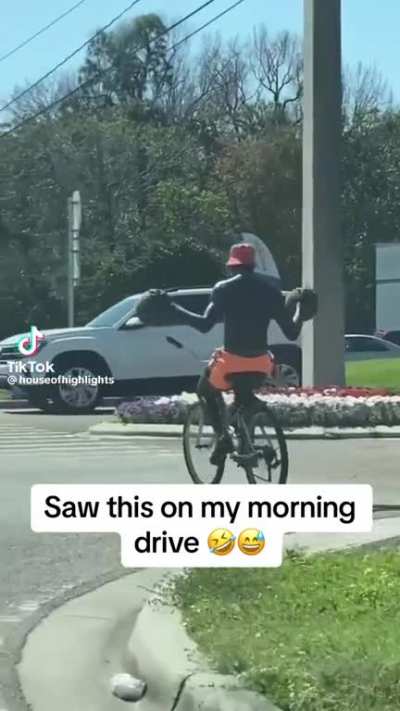 Dribbling two basketballs while riding a bike