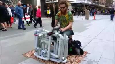 Some kinda hobo street-musician only known as "Pipe-Guy" and his selfmade "Pipe-Slapaphone"?