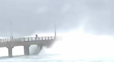 WCGW standing on a pier during a cyclone‽