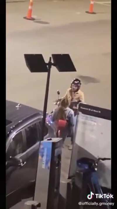 Guy on a moped stuck in a love triangle yells dramatically at woman in the street, then putters off in fury.