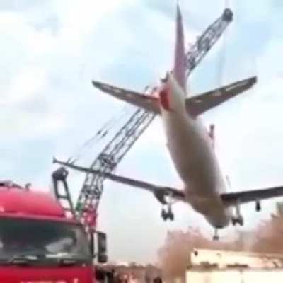 Crane breaks while carrying a scrap plane. Unknown date